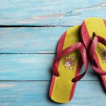 Thongs with flag of Spain, on blue wooden boards